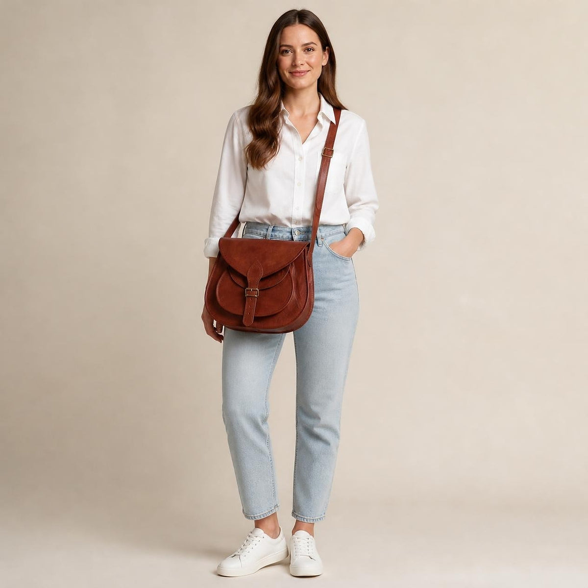 DEKVIO 13 inch leather saddle bag shown at true size on a woman, full length