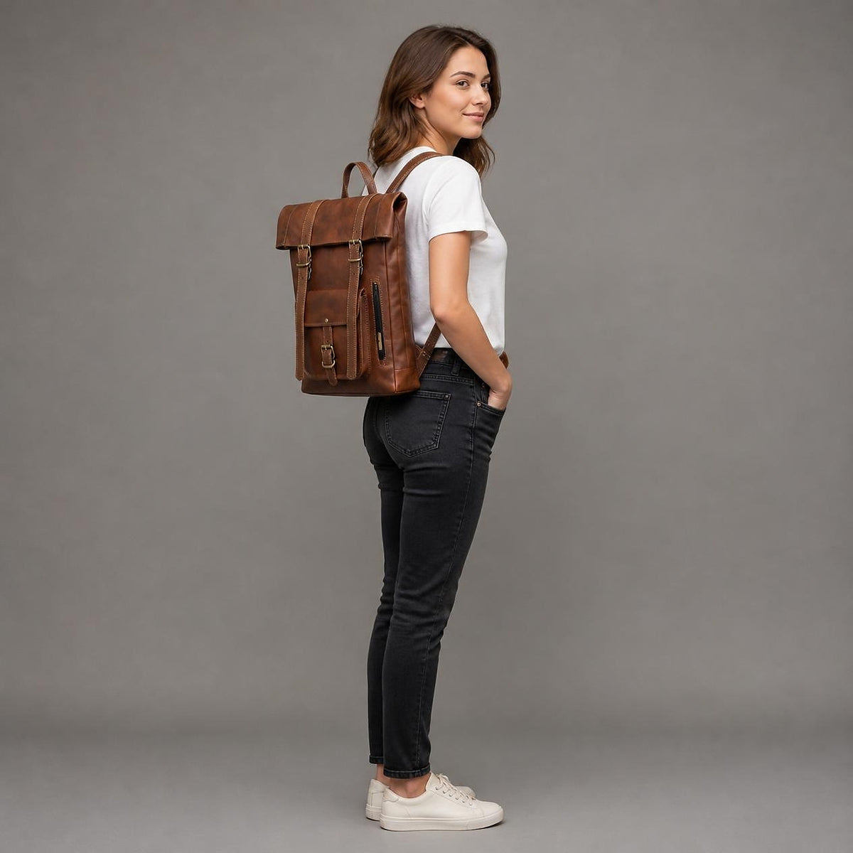 Full-length studio shot showing the roll-top backpack's true size and slim depth