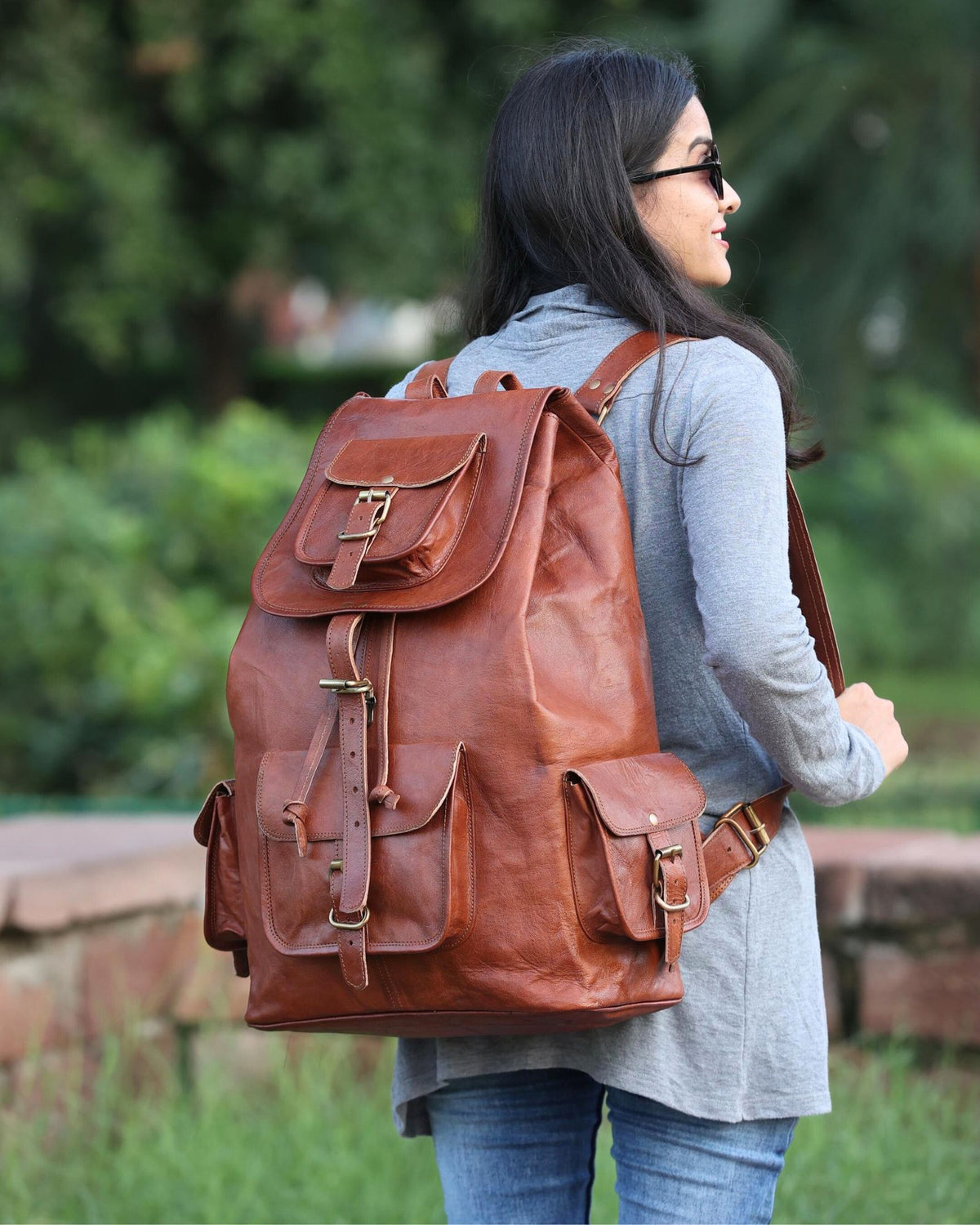 Woman wearing the DEKVIO 20 inch brown leather backpack outdoors