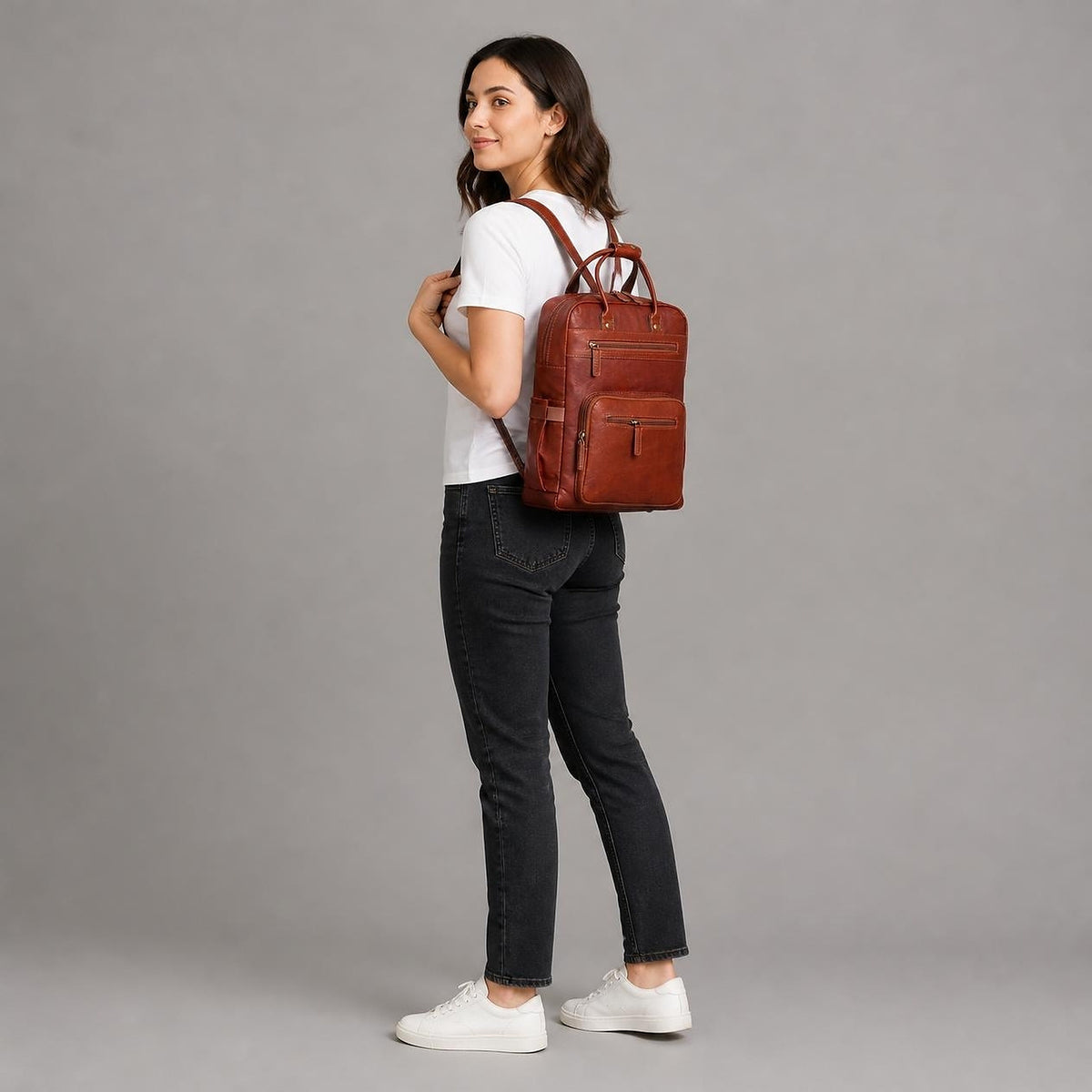 DEKVIO 16 inch leather laptop backpack shown at true size and slim 5 inch depth