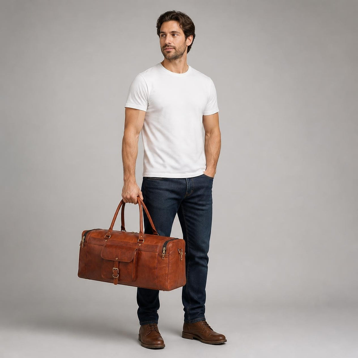 Full-length studio shot showing the duffle at its true 24-inch size beside a man
